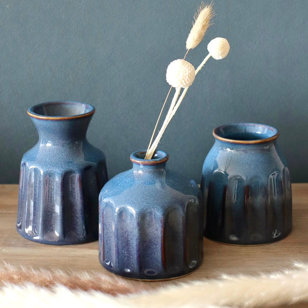 Blue ceramic vases on shelf