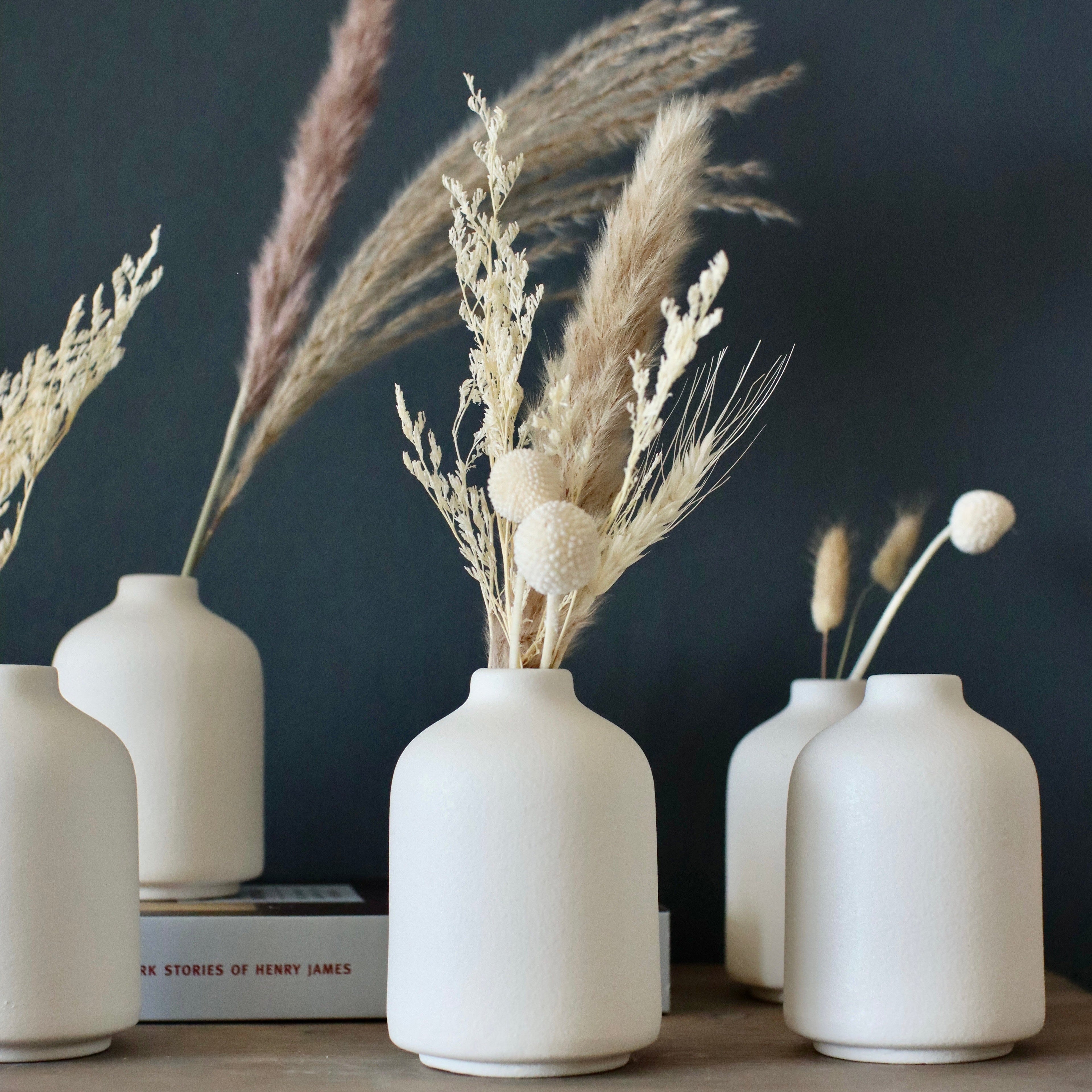 Set of 6 white ceramic bud vases together