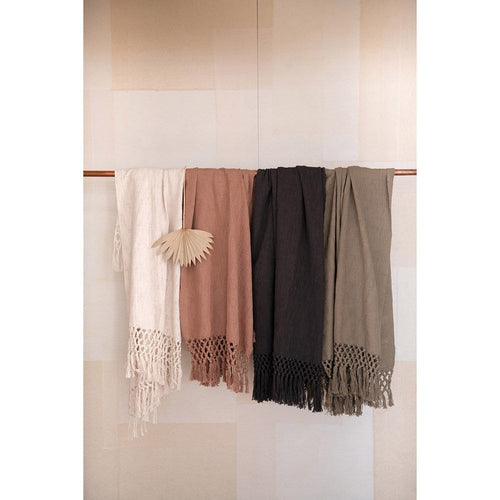 Cotton throw blanket draped over sofa