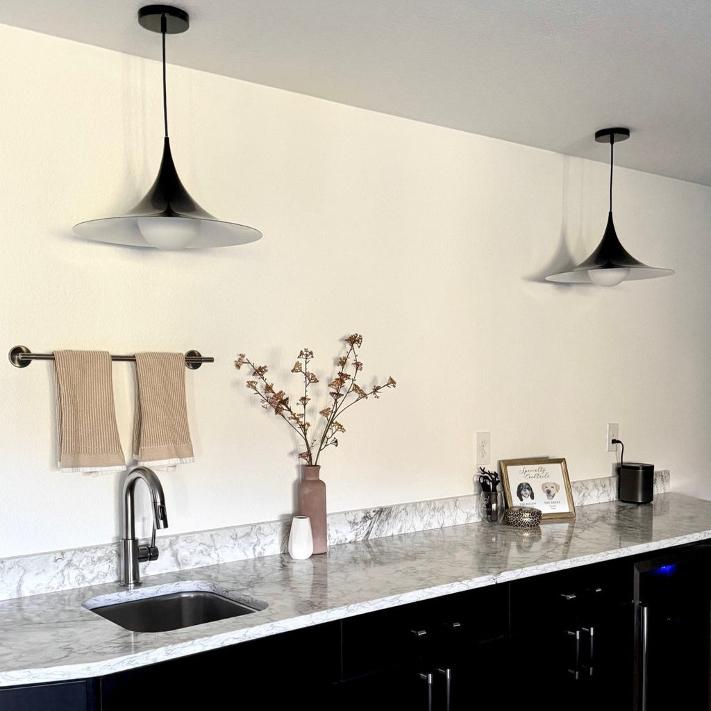 Sage green pendant lamp illuminated in a modern kitchen