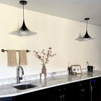 Sage green pendant lamp illuminated in a modern kitchen