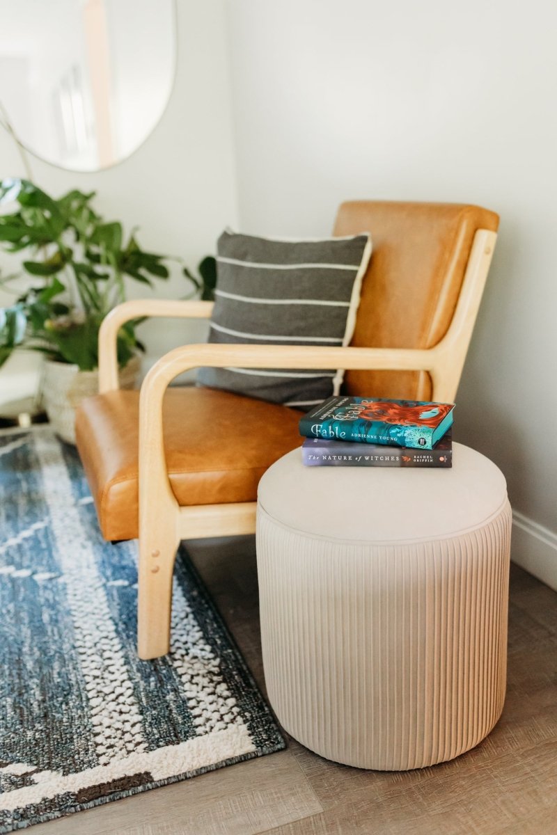 Pumpkin-shaped ottoman styled on a living room rug