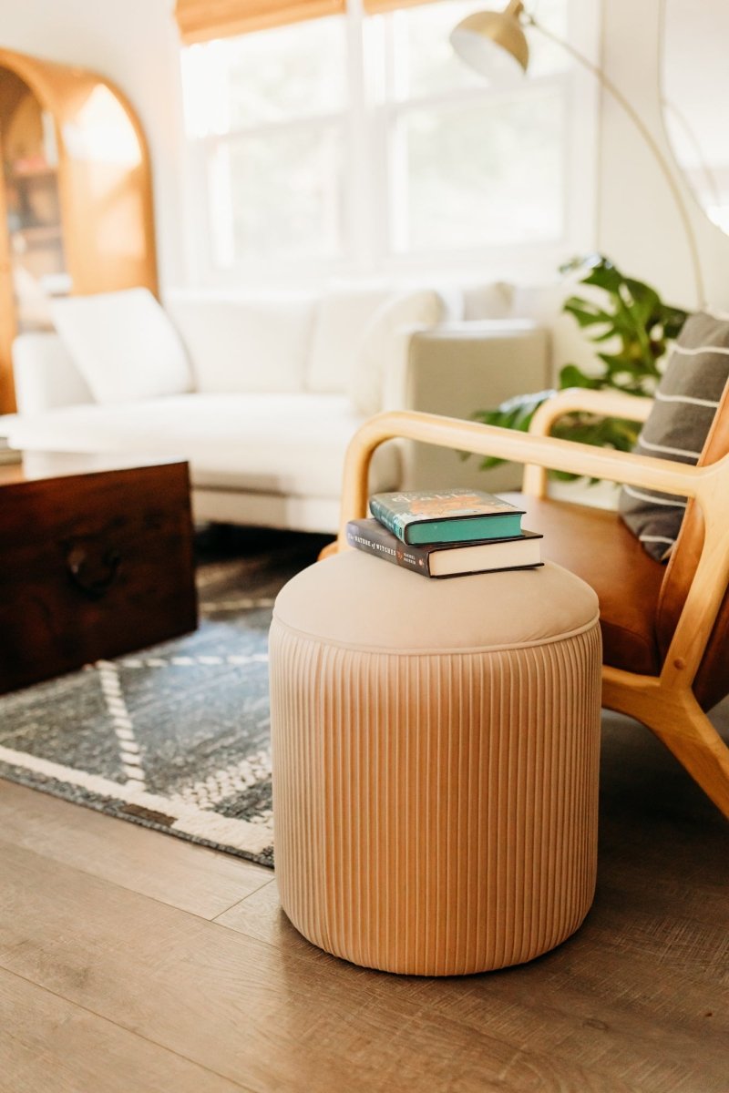 Quinn Ottoman in Pumpkin color - side profile with slender metal legs