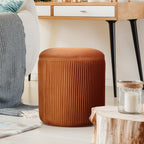 Velvet ottoman as footrest beside sofa