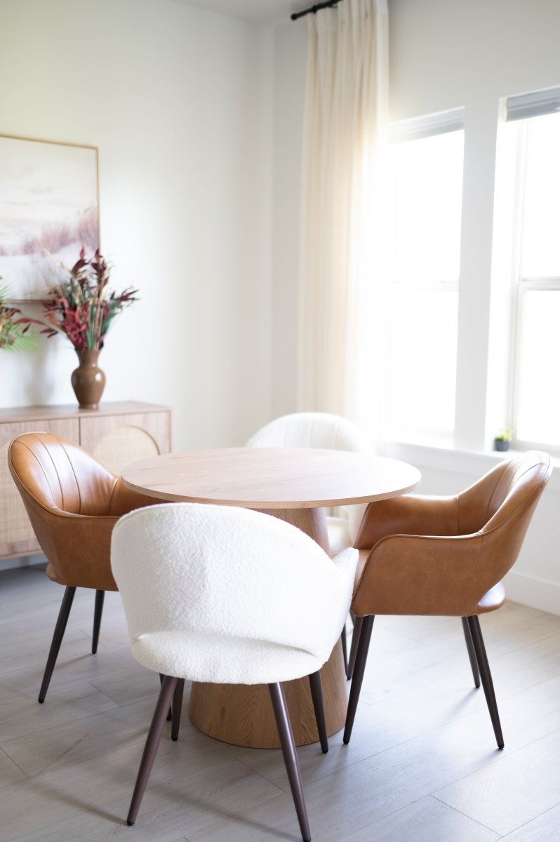 Set of 2 curved dining chairs paired with a round dining table