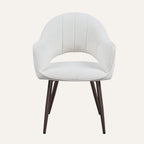 Contemporary dining chairs in ivory boucle around a dining table