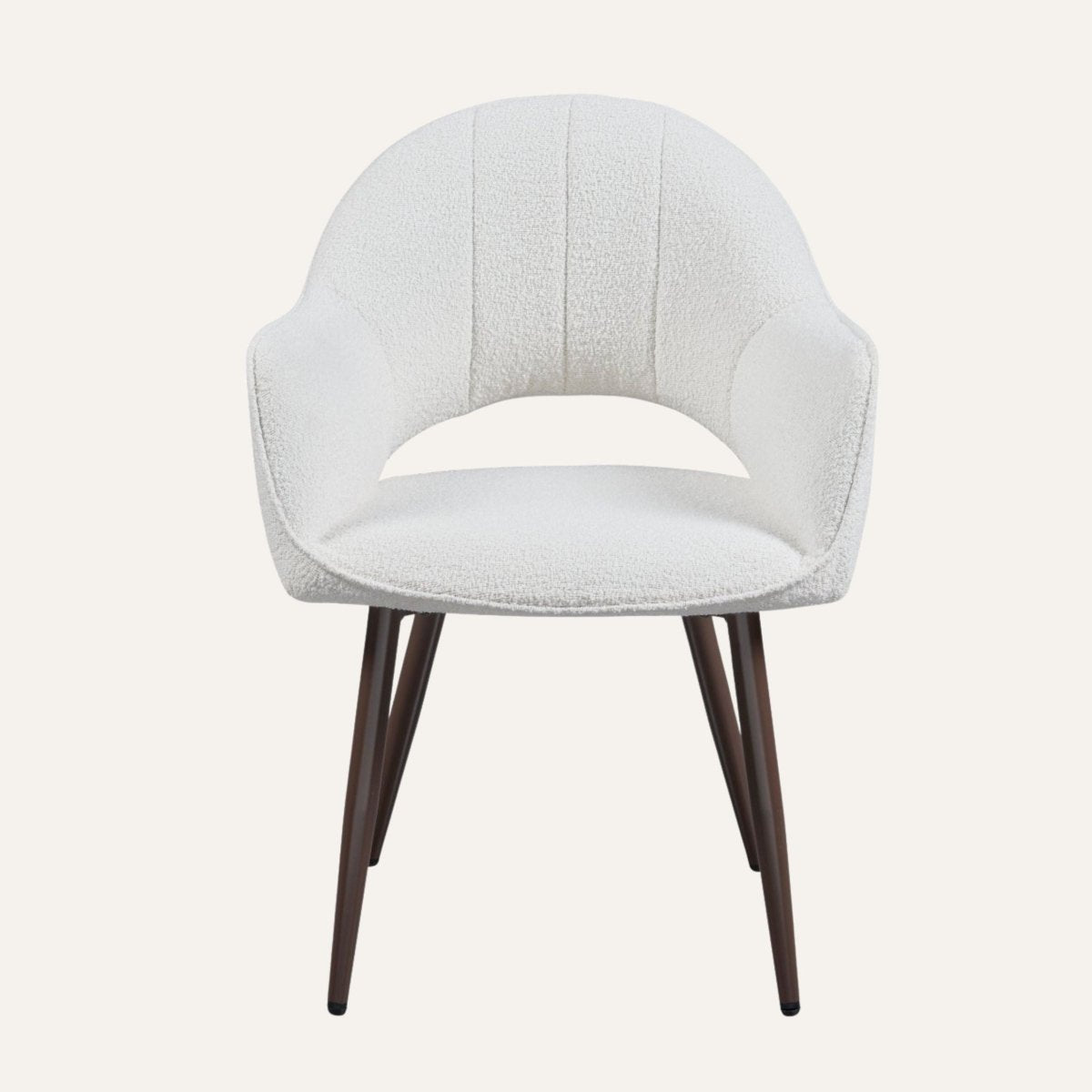 Contemporary dining chairs in ivory boucle around a dining table